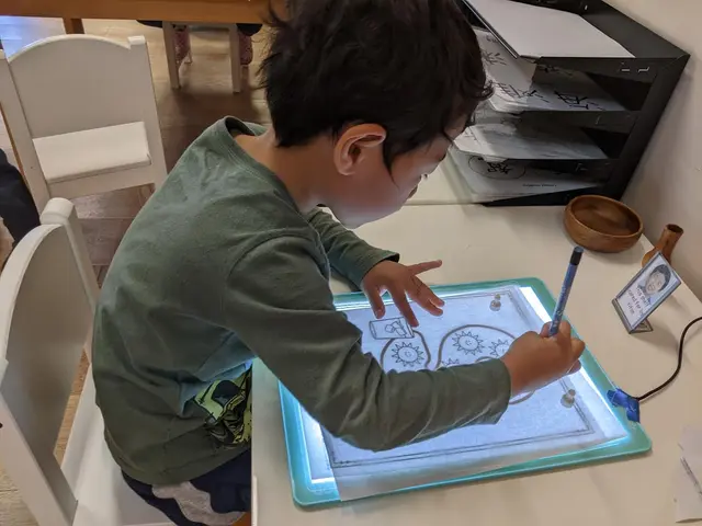 Child tracing on a light table