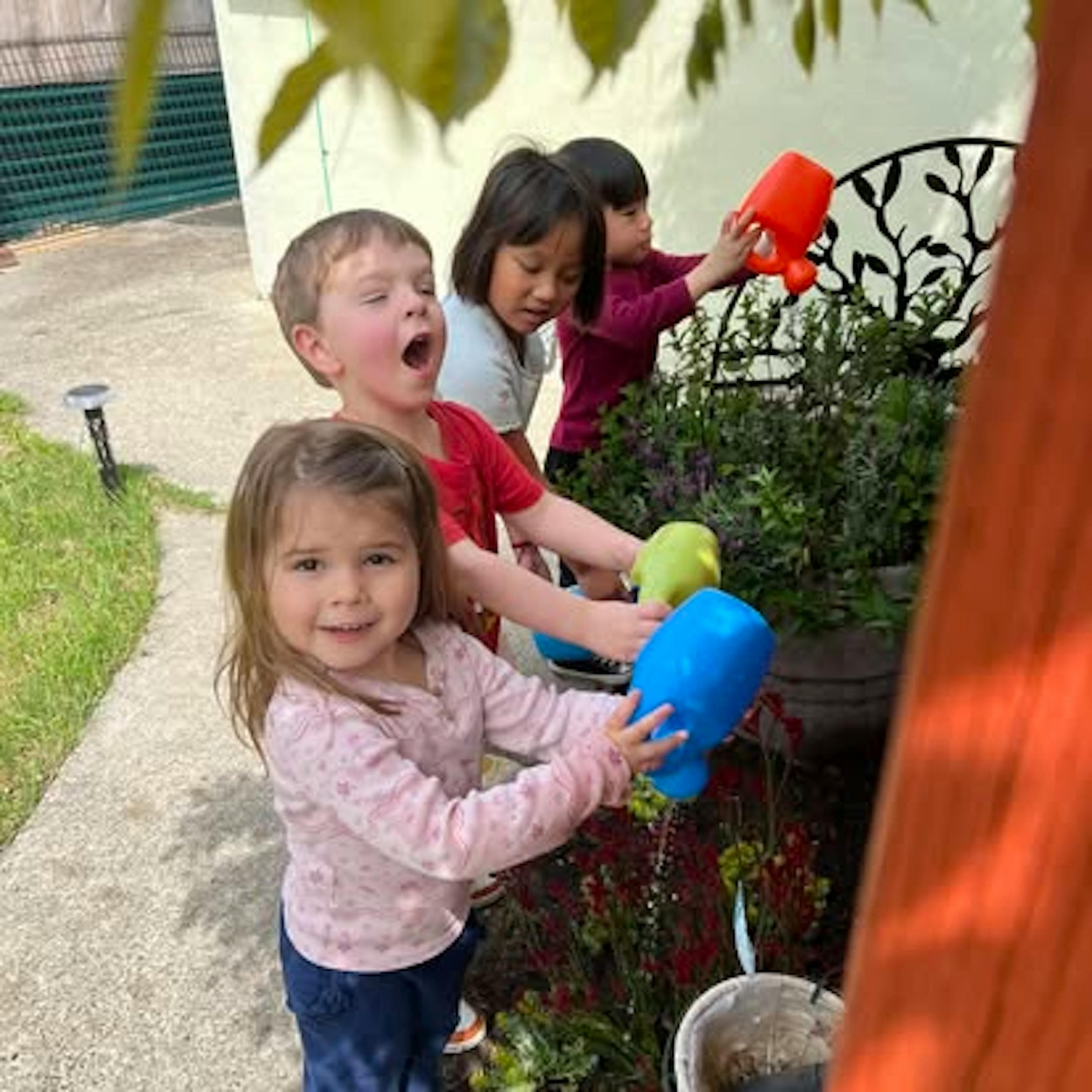 Child watering the garden