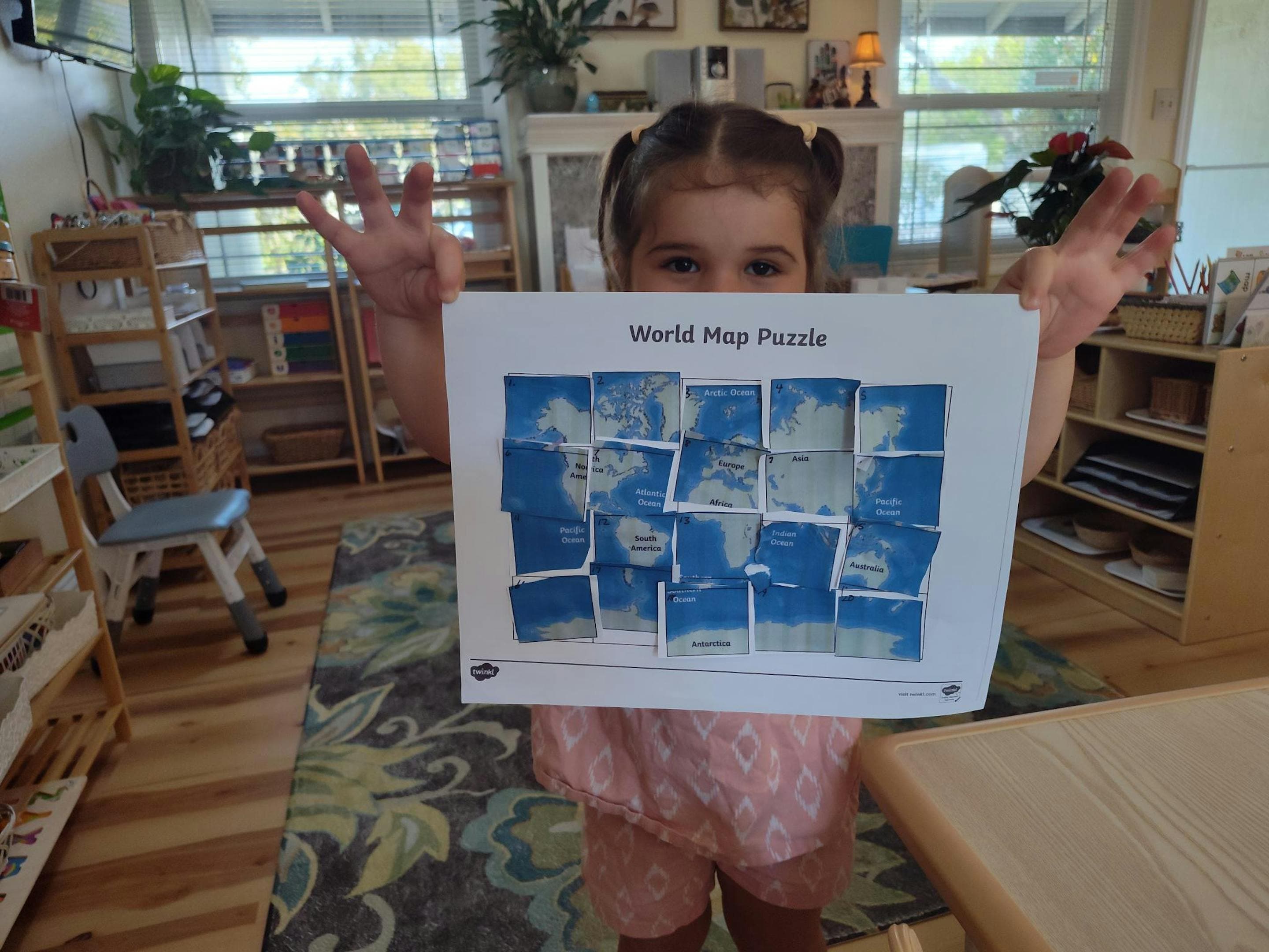 Child working on the world map puzzle